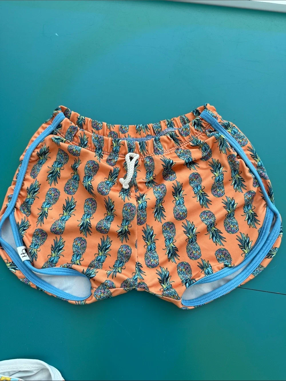 Kids Orange Pineapple Swim Trunks with Blue Trim